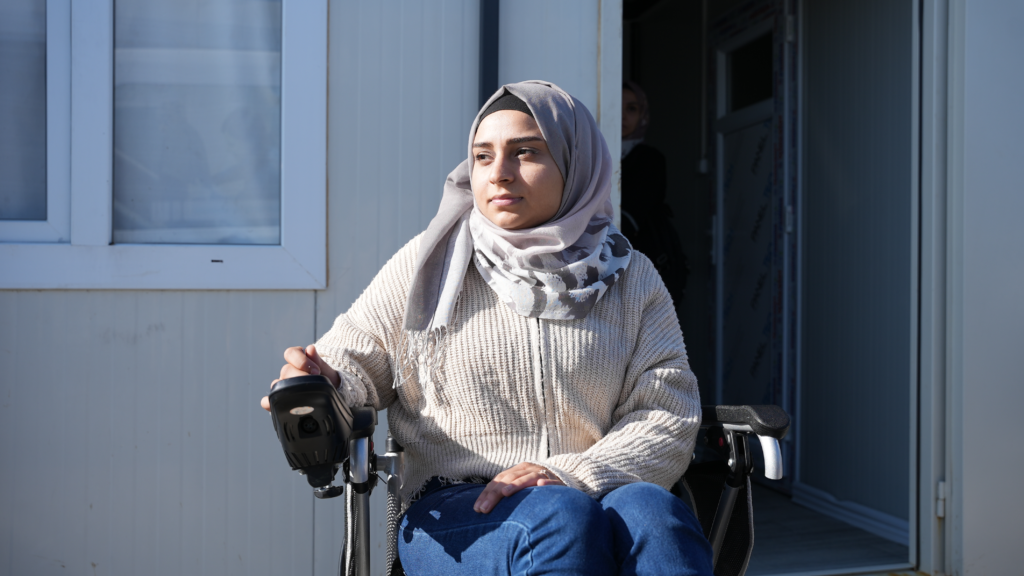 Walla using electric wheelchair received from IDA