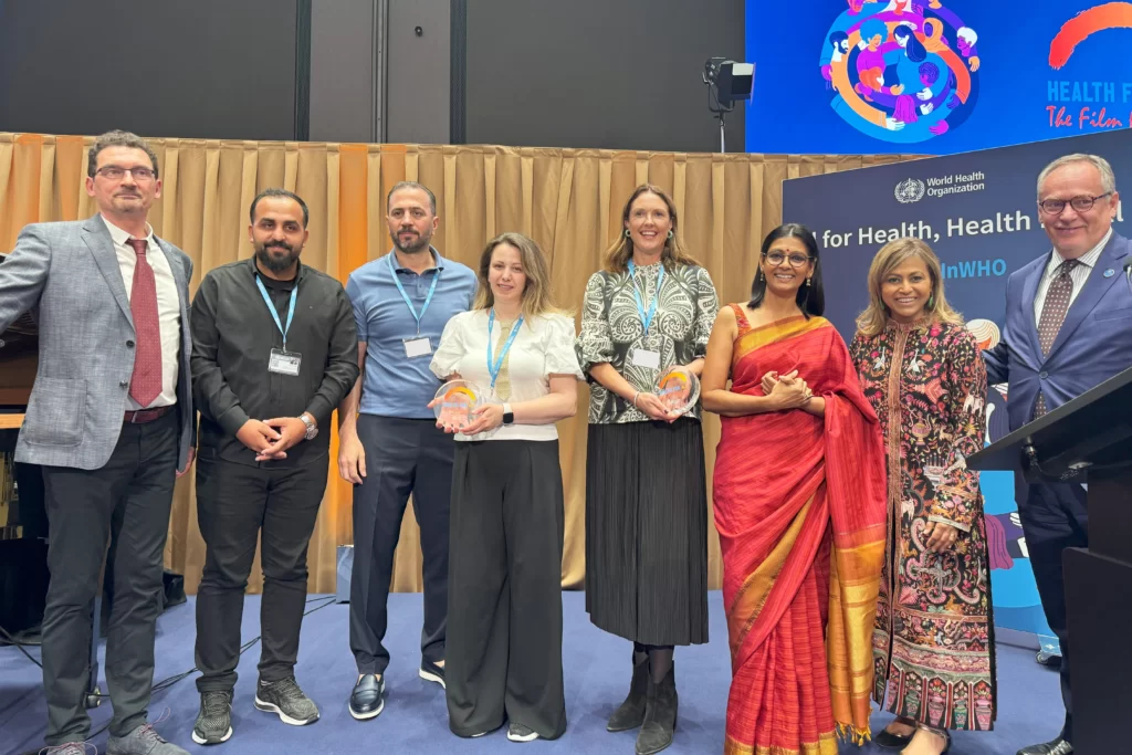 IDA General Director Dr. Mahmud Mustafa receiving the trophy at the film festival in Geneva.